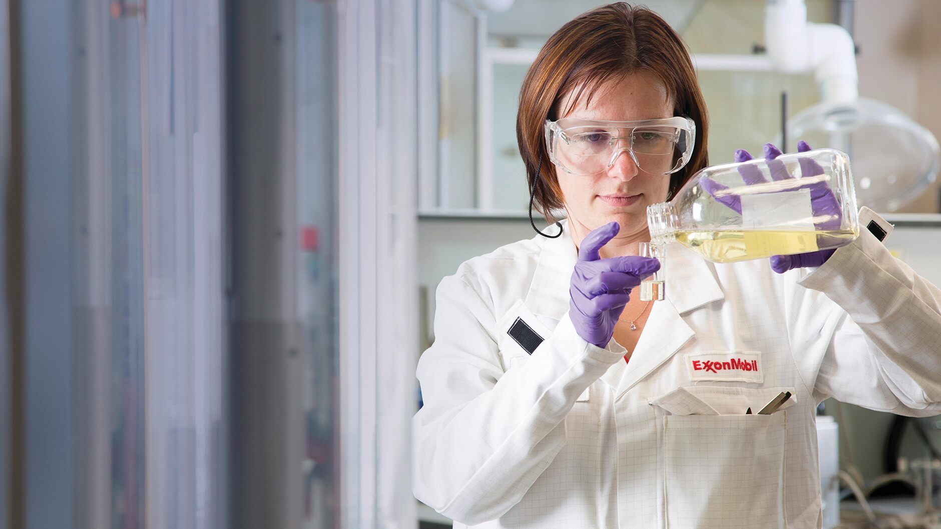 A scientist pouring a chemical