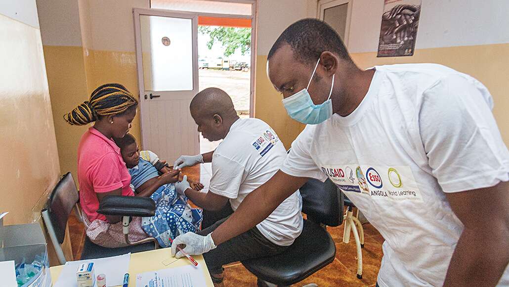 A woman with her child getting a malaria vaccination