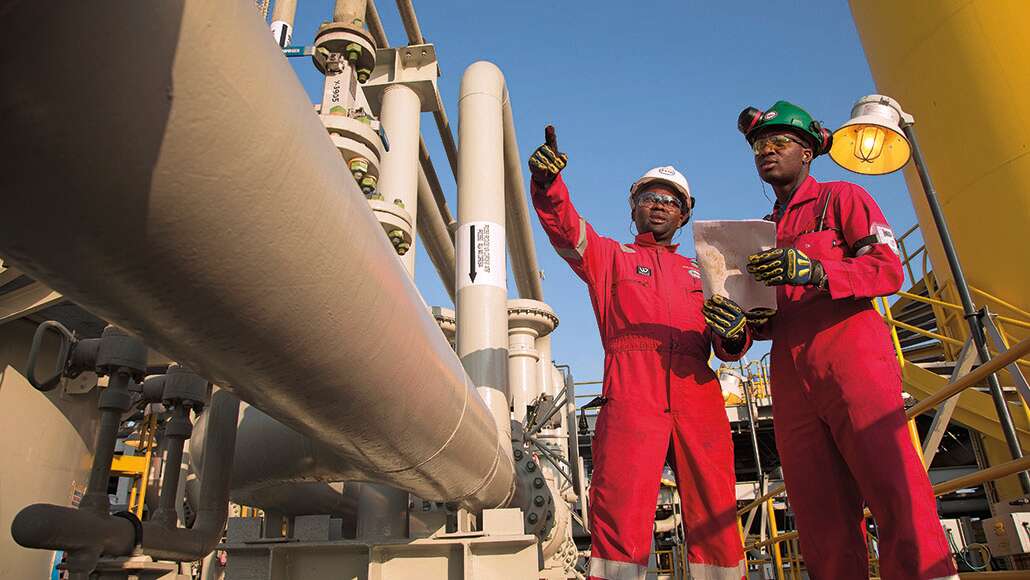 Two male ExxonMobil workers on-site