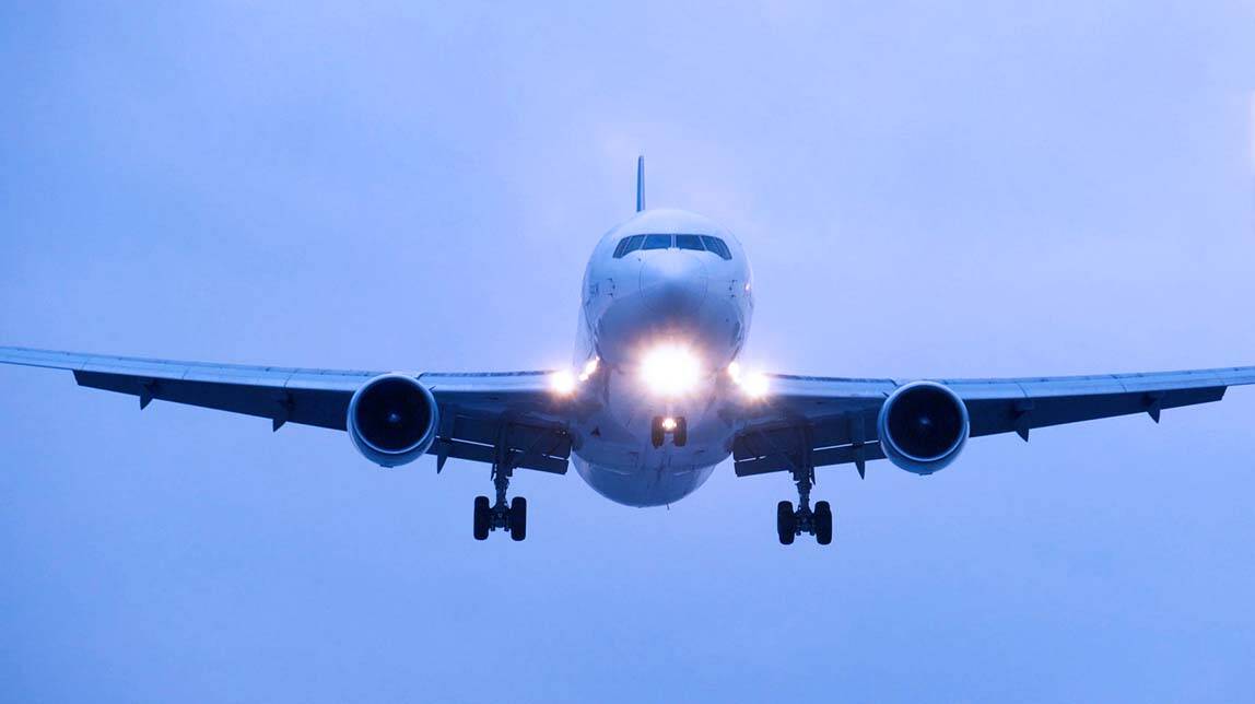 airplane in the sky with landing gear down