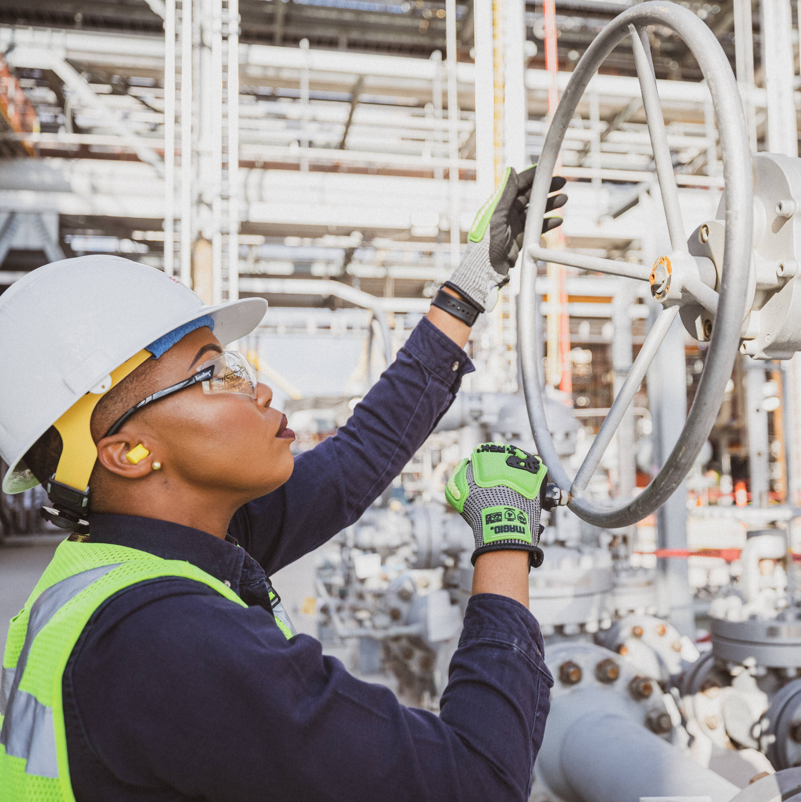 worker adjusting a valve at Baytown facility