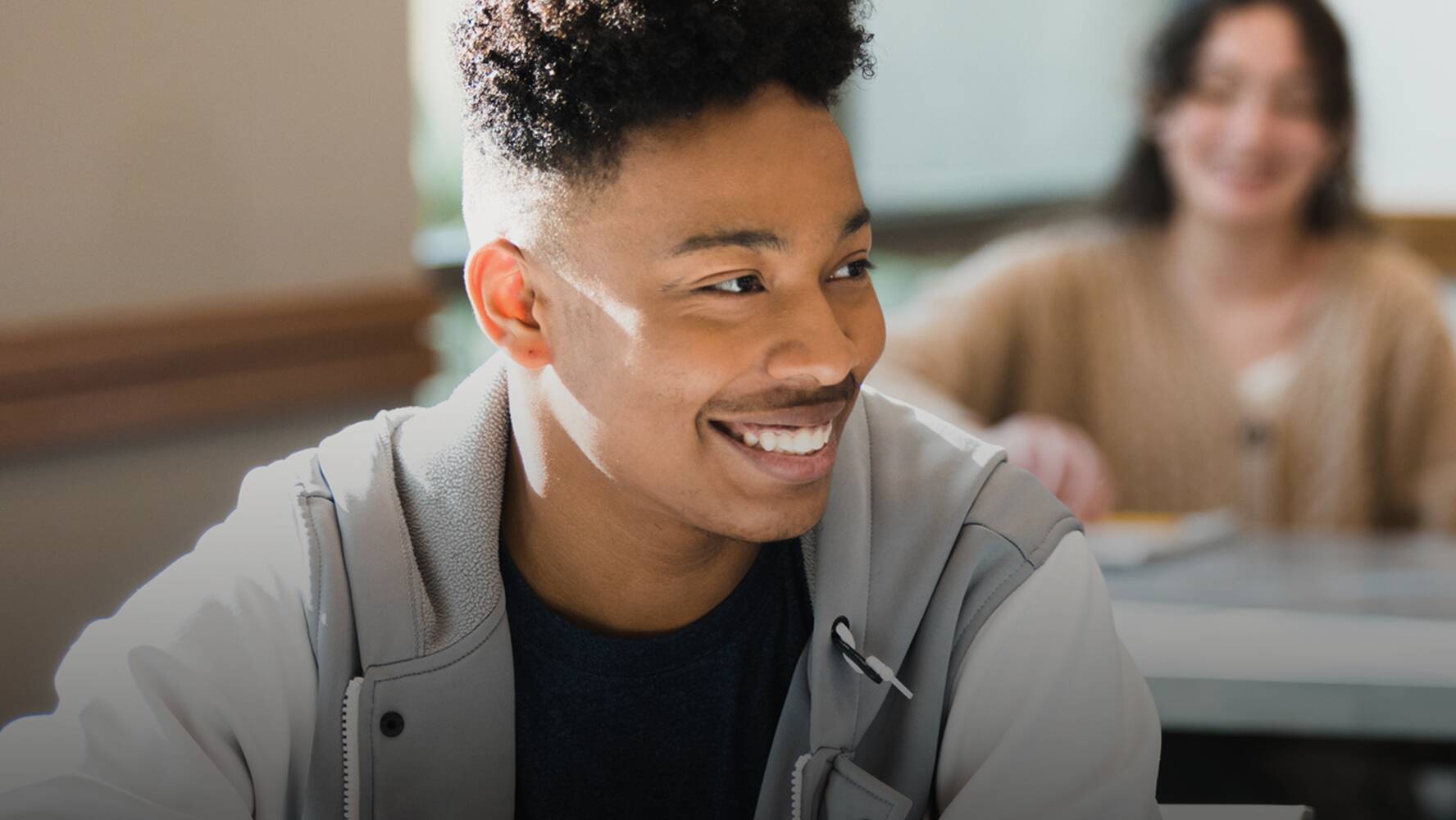 Student in a classroom smiling.