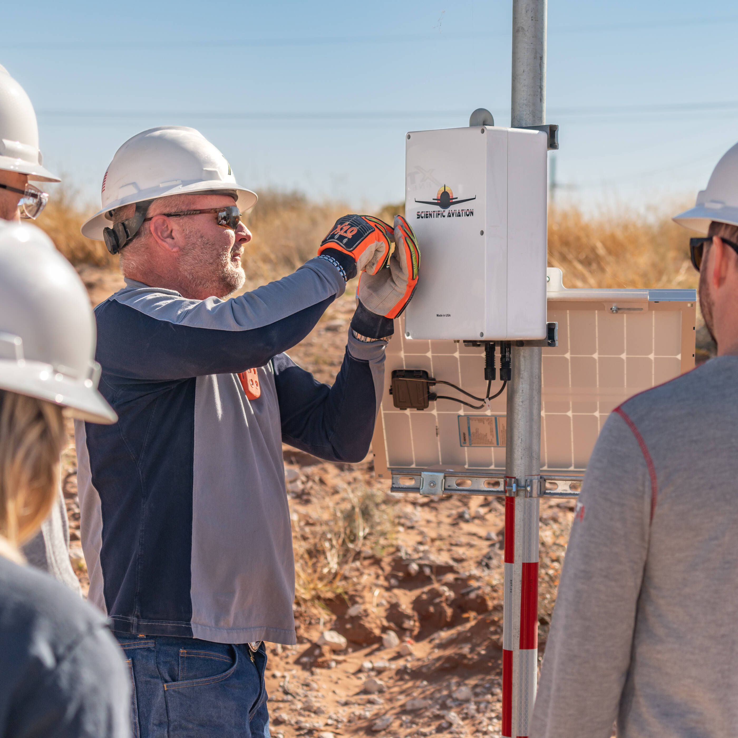 Employees installing ground based sensors. 