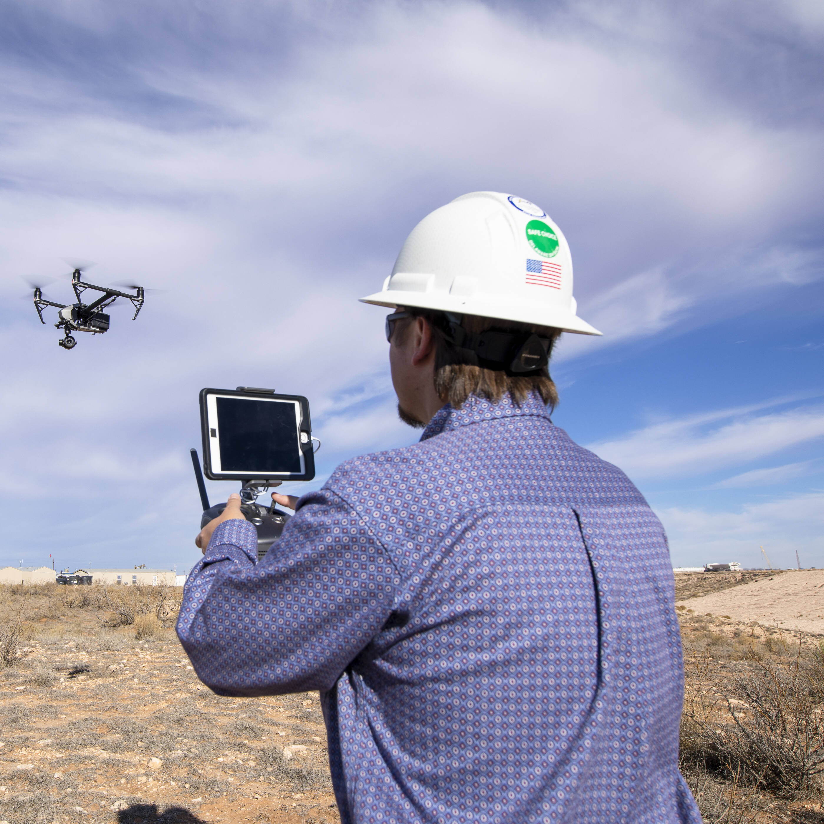 ExxonMobil employee flying a drone over a refinery.